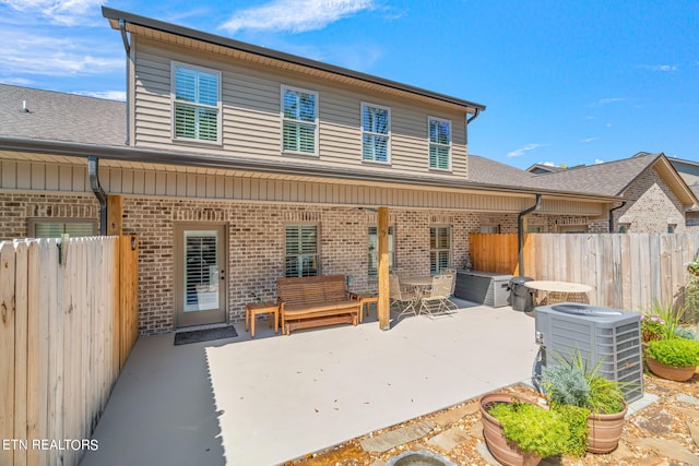 rear view of house featuring central AC and a patio area