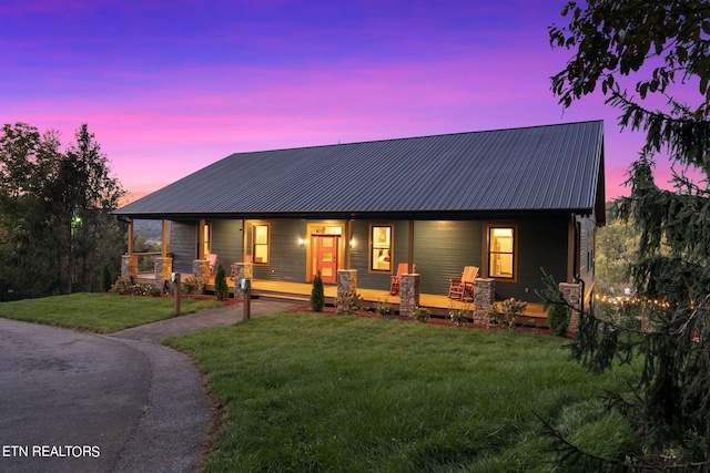 view of front of house with a lawn and covered porch