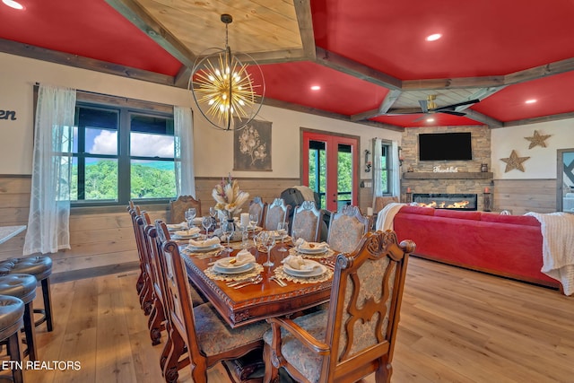 dining space with an inviting chandelier, beamed ceiling, hardwood / wood-style floors, and a wealth of natural light