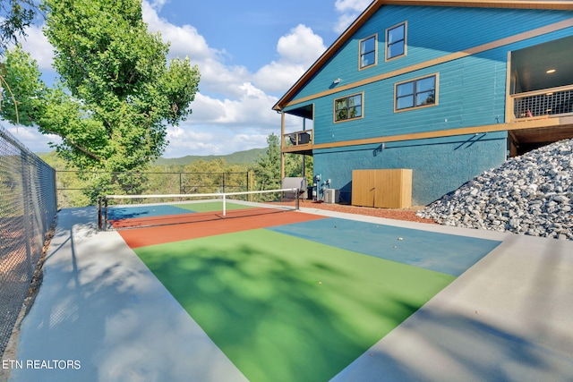 view of basketball court featuring a mountain view and tennis court