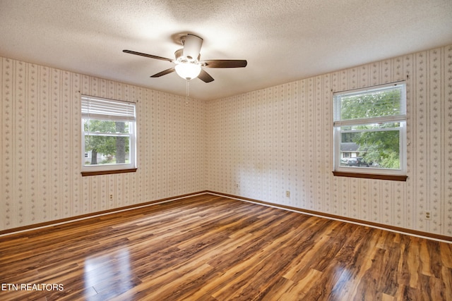 spare room with ceiling fan, hardwood / wood-style floors, and a textured ceiling