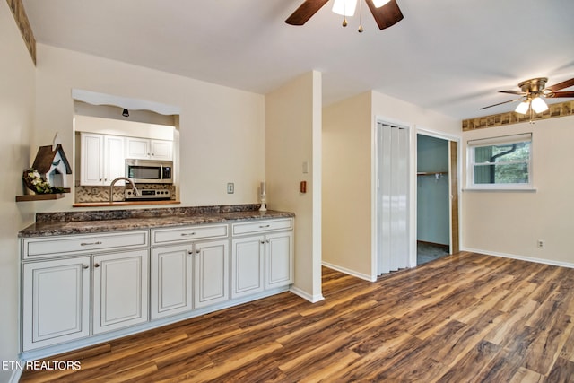 kitchen with ceiling fan, white cabinets, backsplash, and dark hardwood / wood-style flooring