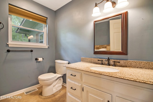 bathroom featuring tile patterned floors, vanity, and toilet