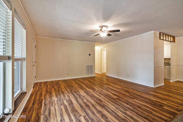 spare room featuring ceiling fan, dark hardwood / wood-style floors, crown molding, and a textured ceiling