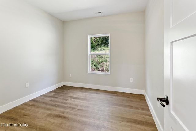 unfurnished room with light hardwood / wood-style flooring