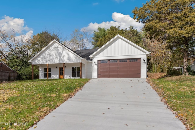 modern inspired farmhouse with a front yard and a garage