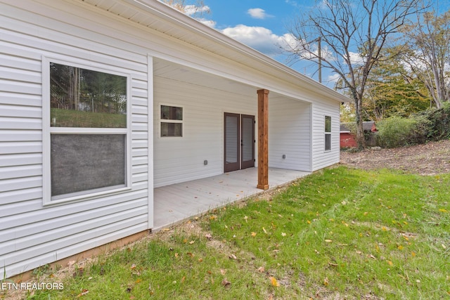 exterior space with a patio and a lawn