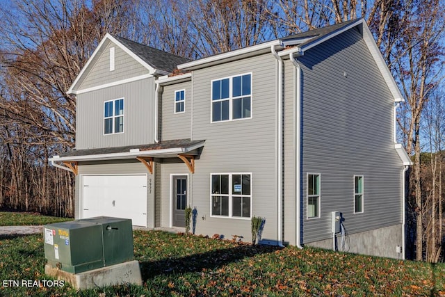 view of front facade with a garage and a front lawn