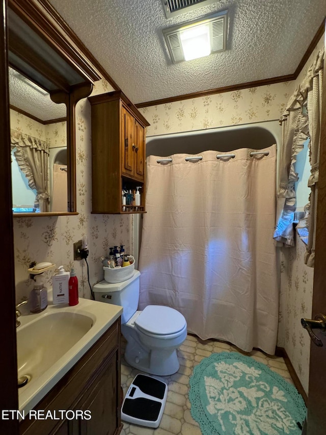 bathroom with a textured ceiling, ornamental molding, vanity, and toilet