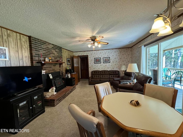 carpeted dining room with ceiling fan, a textured ceiling, and a wood stove