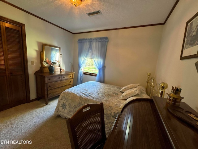 bedroom with ornamental molding, a closet, a textured ceiling, and carpet floors