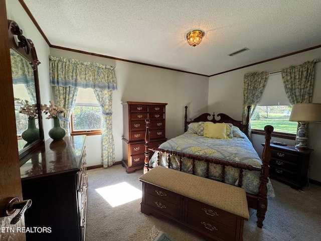 bedroom with a textured ceiling, light colored carpet, and crown molding