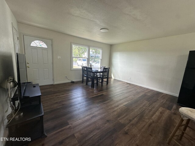 entryway featuring a textured ceiling and dark hardwood / wood-style flooring