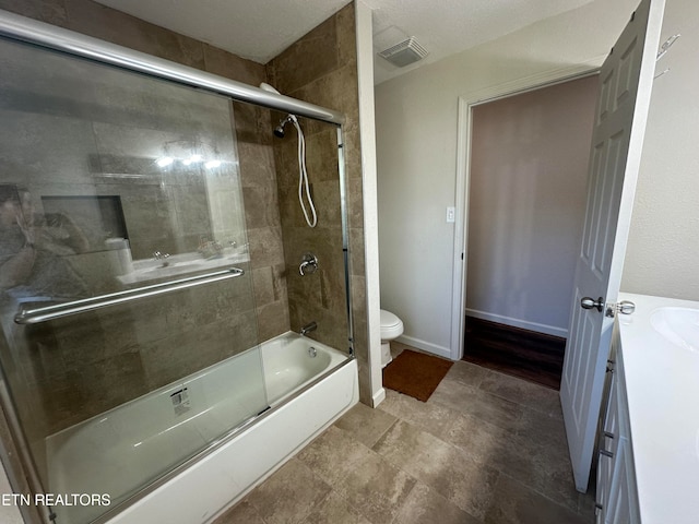 full bathroom with enclosed tub / shower combo, vanity, toilet, and a textured ceiling