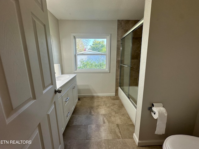 full bathroom featuring shower / bath combination with glass door, vanity, and toilet