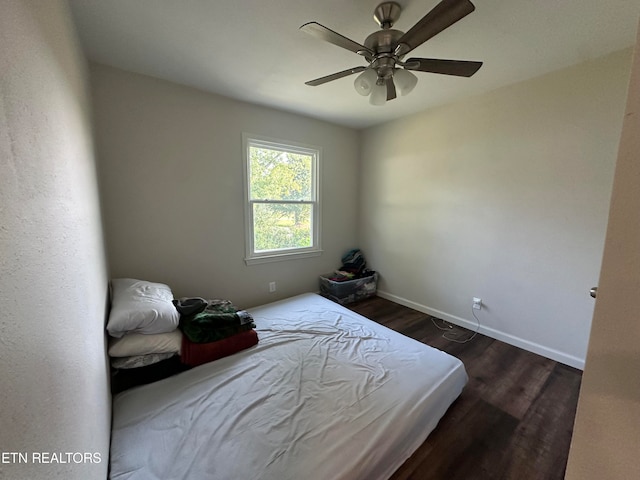 bedroom with ceiling fan and dark hardwood / wood-style flooring