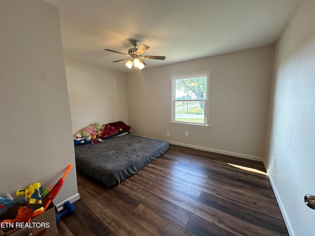 bedroom featuring ceiling fan and dark hardwood / wood-style floors