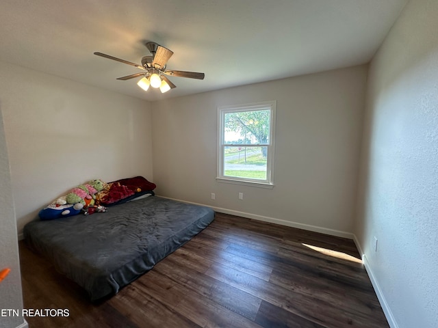 bedroom with ceiling fan and dark hardwood / wood-style floors