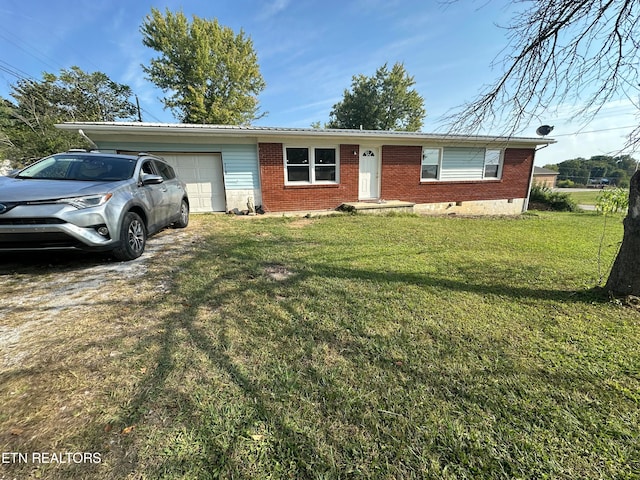 single story home featuring a garage and a front lawn