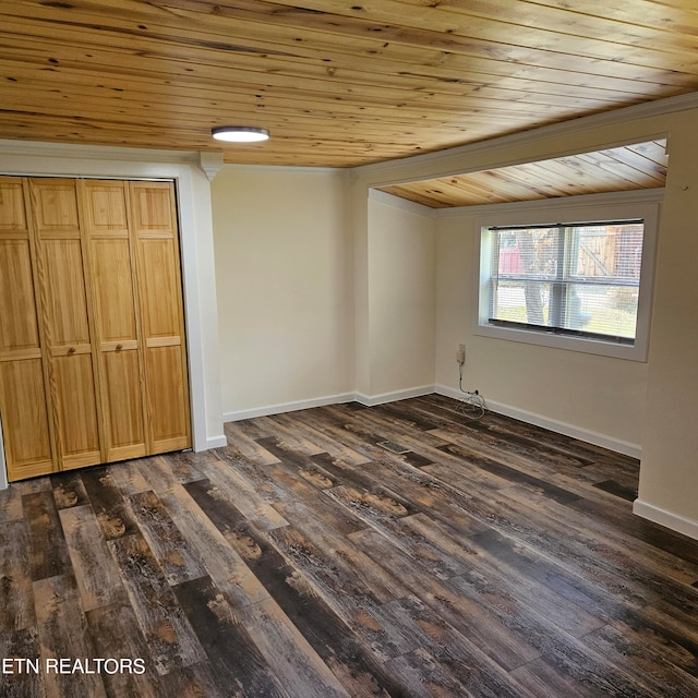 unfurnished bedroom with wooden ceiling, dark hardwood / wood-style floors, and a closet