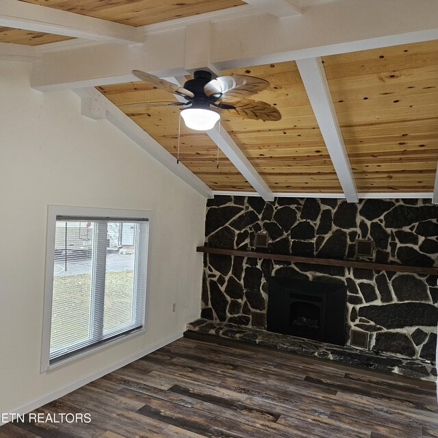 unfurnished living room with lofted ceiling with beams, a stone fireplace, wooden ceiling, ceiling fan, and hardwood / wood-style floors