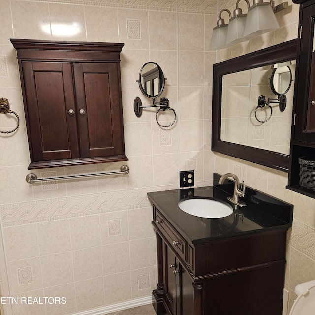 bathroom with vanity and tile walls