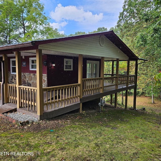 view of home's exterior featuring a lawn and a wooden deck