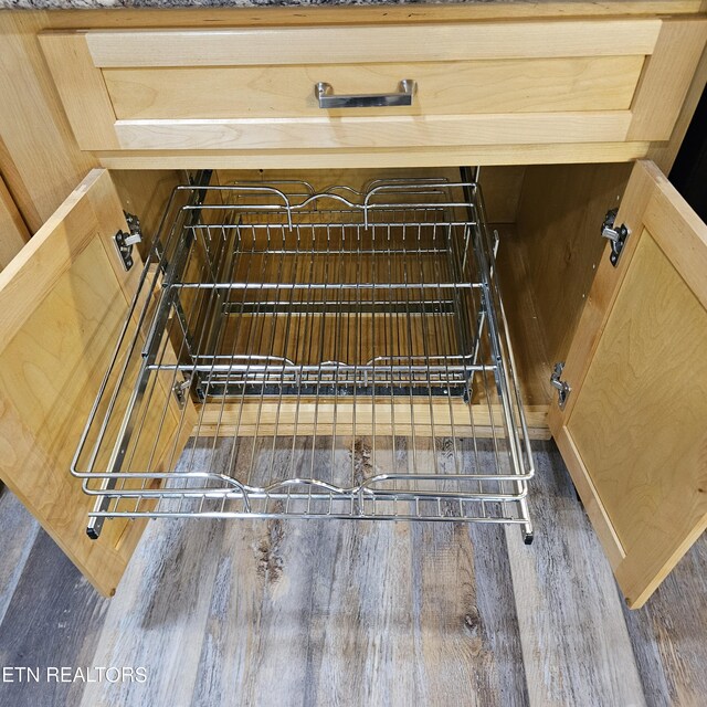 details featuring light brown cabinets and dark wood-type flooring