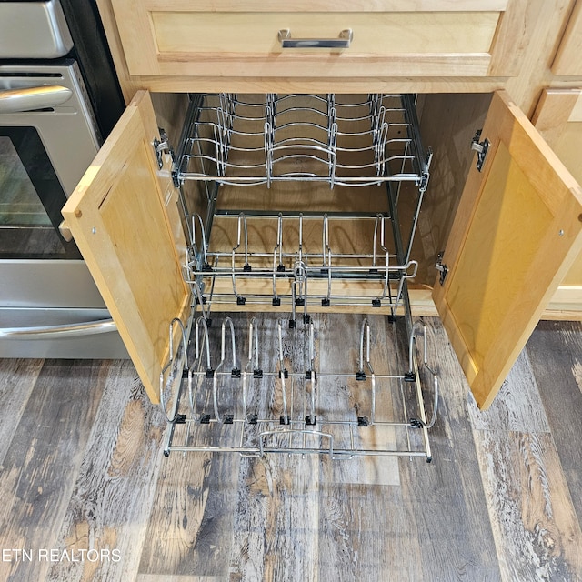 details with light brown cabinets and dark wood-type flooring