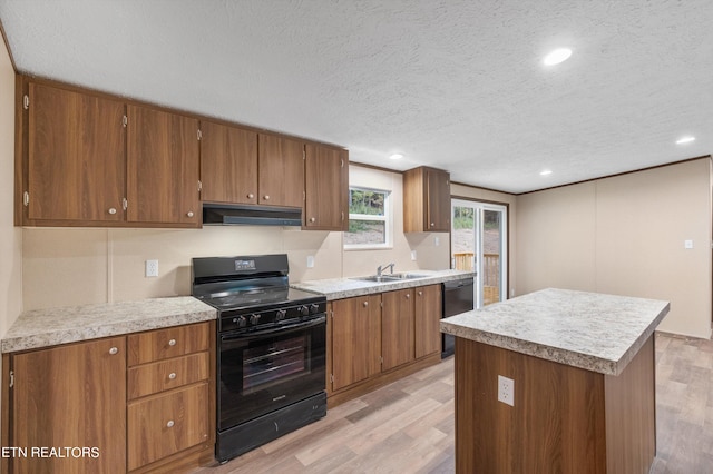 kitchen featuring a textured ceiling, light hardwood / wood-style flooring, extractor fan, black appliances, and a center island