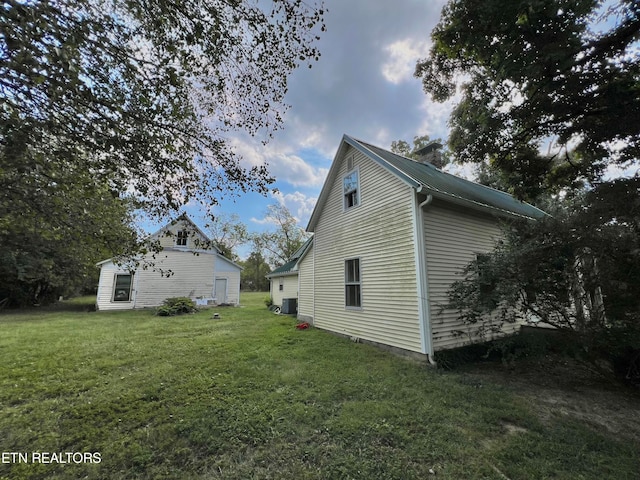 view of property exterior featuring a yard and central air condition unit