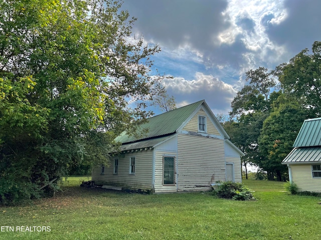 view of home's exterior with a lawn