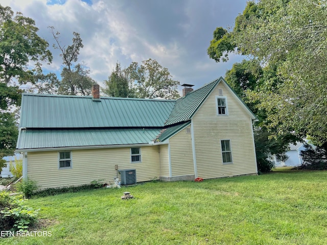 view of home's exterior with a lawn and central air condition unit