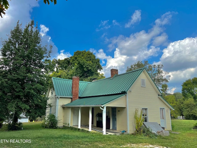 rear view of house with a yard