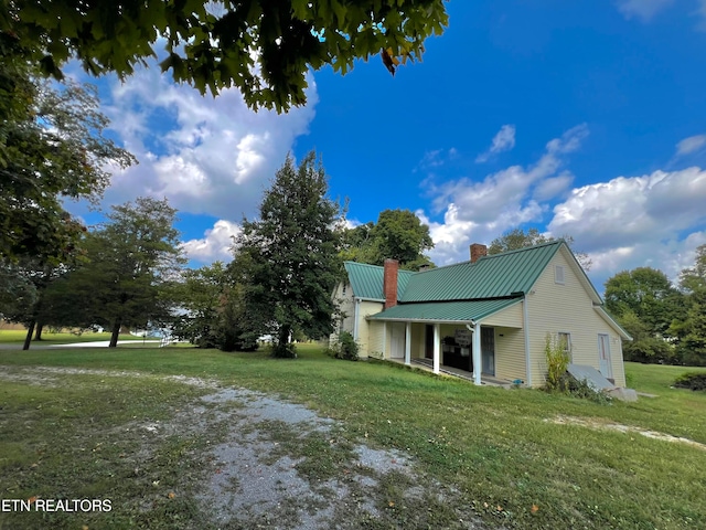 view of side of home featuring a yard