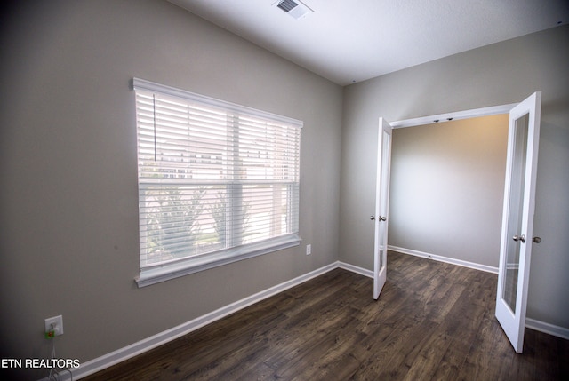 unfurnished bedroom with dark wood-type flooring