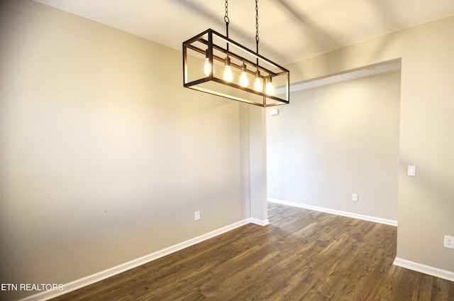 empty room featuring dark hardwood / wood-style flooring