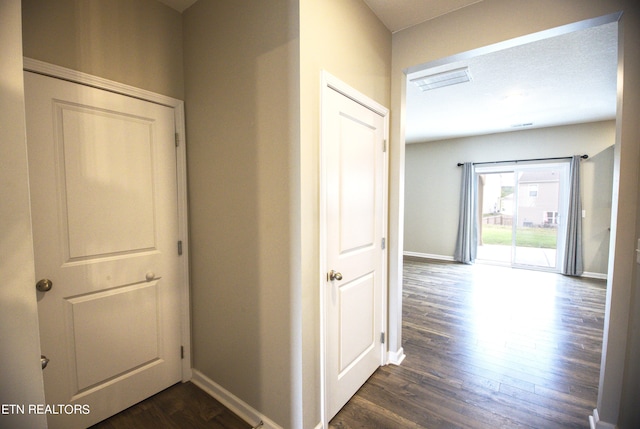 corridor featuring dark hardwood / wood-style flooring