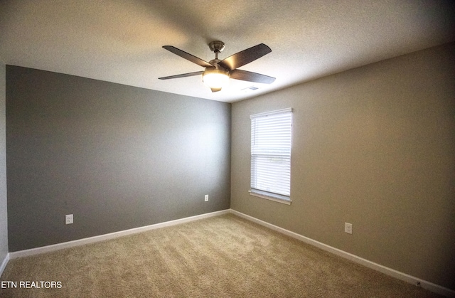 empty room featuring carpet flooring and ceiling fan