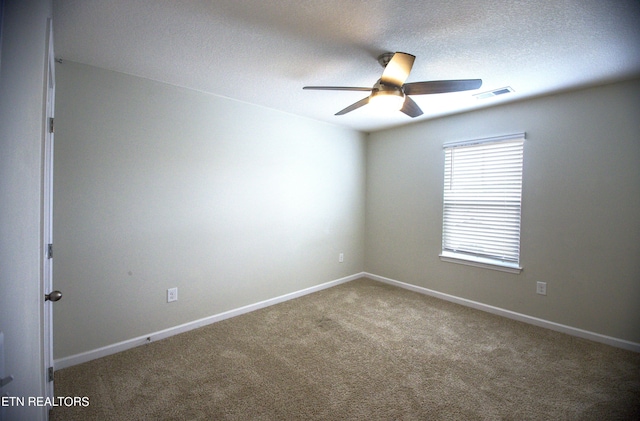 spare room with ceiling fan, carpet floors, and a textured ceiling