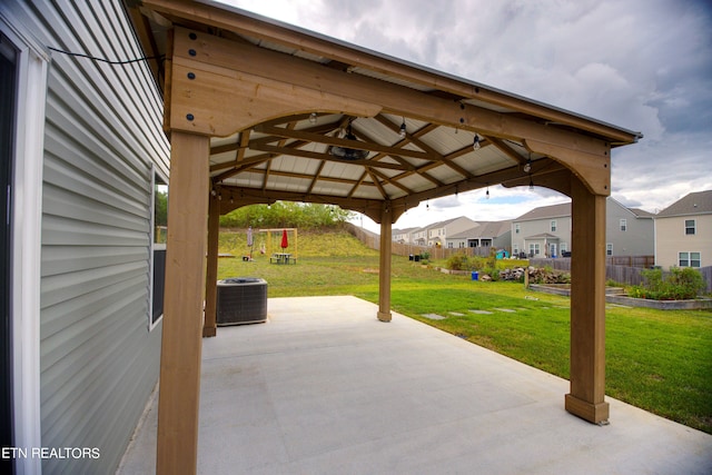 view of patio / terrace featuring a gazebo, ceiling fan, and central AC unit