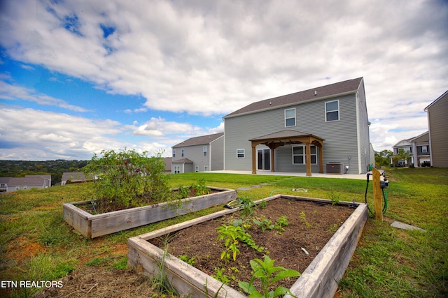 back of property featuring a gazebo, a lawn, a patio, and central air condition unit