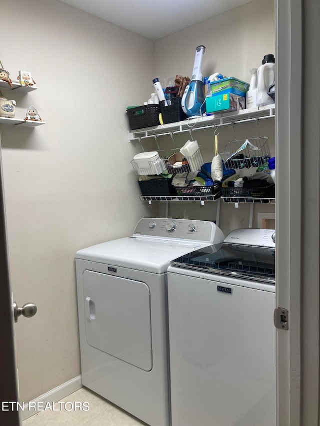 laundry room with light tile patterned floors and washer and dryer