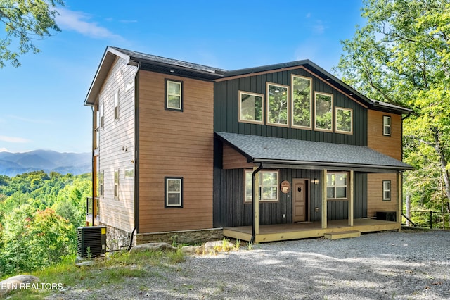 view of front of house featuring a mountain view, a porch, and central AC