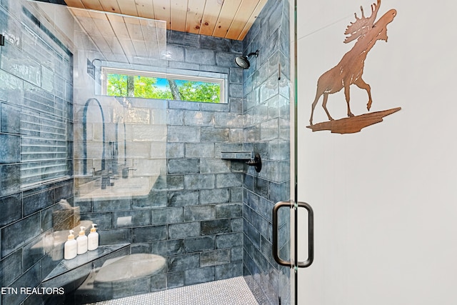 bathroom with wood ceiling and an enclosed shower