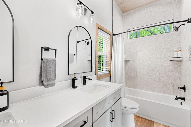 full bathroom with shower / bath combination with curtain, vanity, plenty of natural light, and toilet