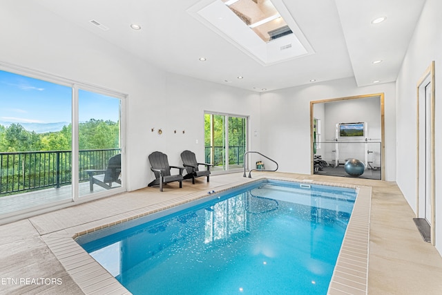 view of pool featuring a skylight