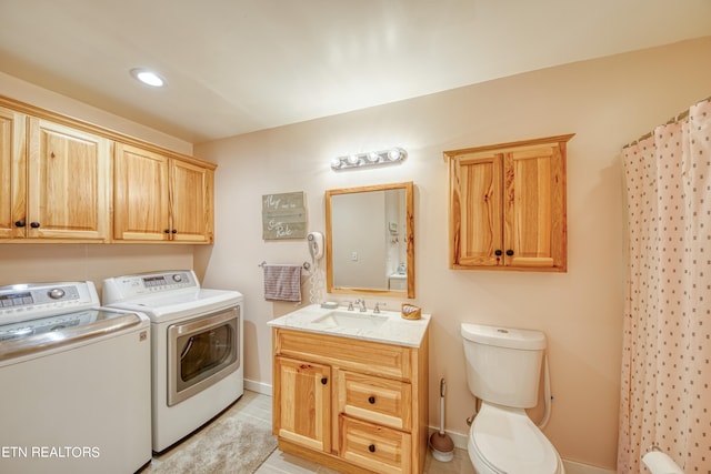 washroom featuring light tile patterned floors, separate washer and dryer, and sink