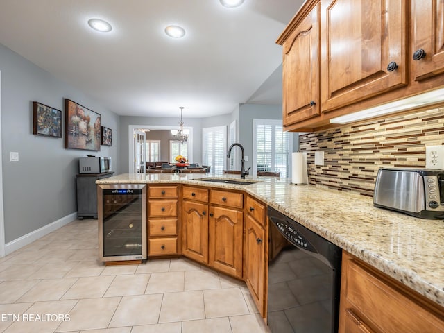 kitchen with wine cooler, hanging light fixtures, sink, kitchen peninsula, and black dishwasher