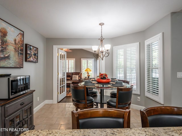 dining area featuring a notable chandelier and light tile patterned floors